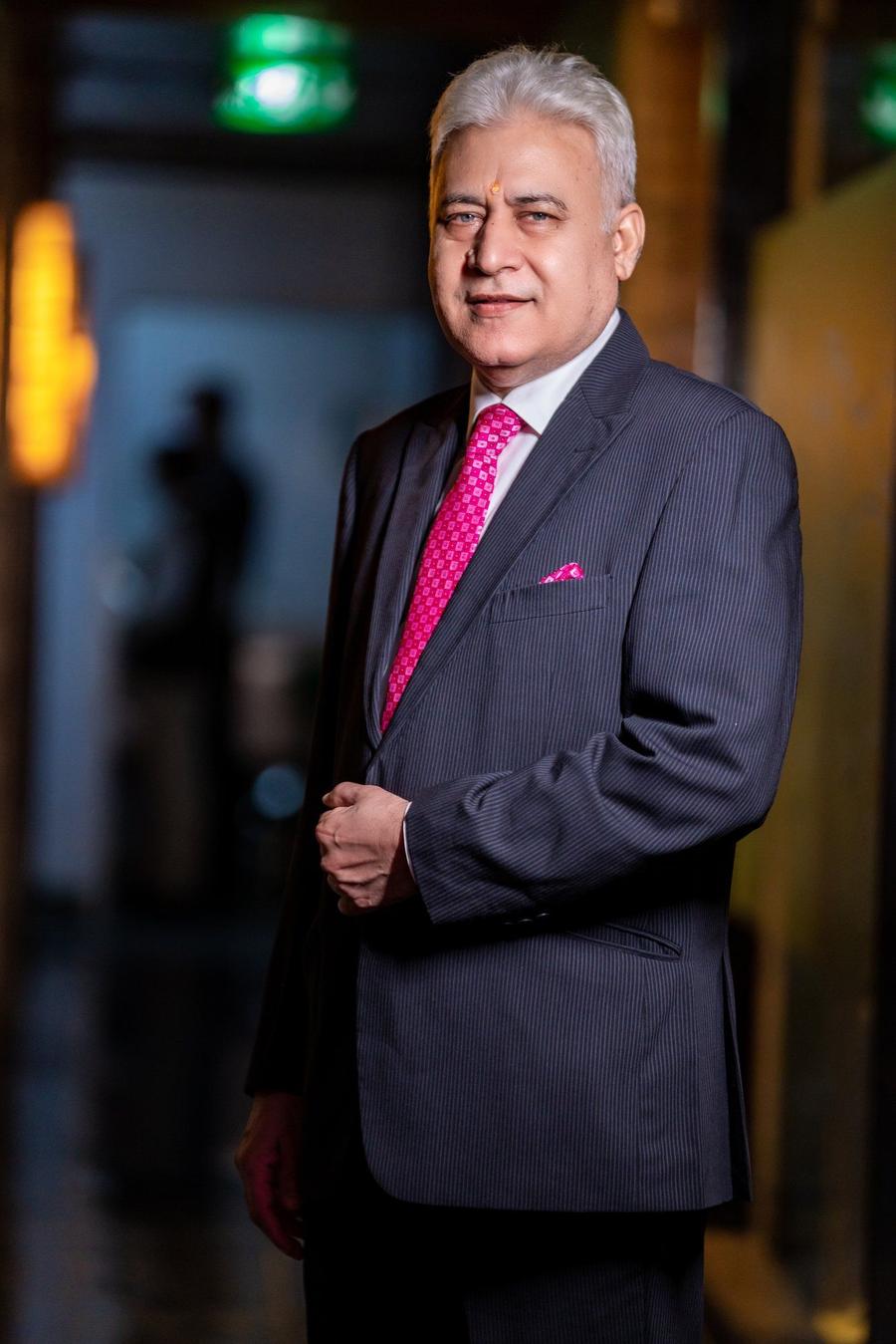 Anil Bholla in a dark suit